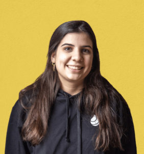 Headshot of our Customer Support Specialist in a black sweater on a yellow background
