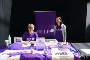 Two Help Auckland members at an informational booth