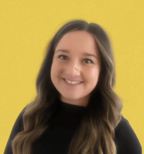 headshot of natalie in a black shirt on a yellow background