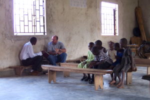 A group of children and instructors sitting inside a place of worship